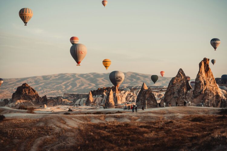 Hot air balloons rising over the rock formations of Cappadocia, Turkey
