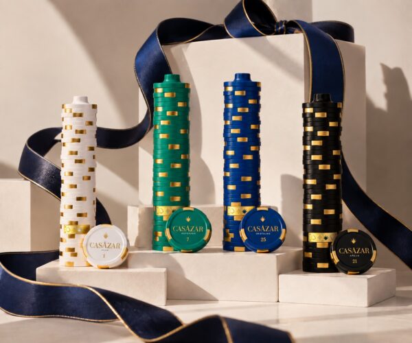 CasAzar Tequila hand-painted porcelain bottles sculpted like stacked casino chips, tied with a navy holiday ribbon