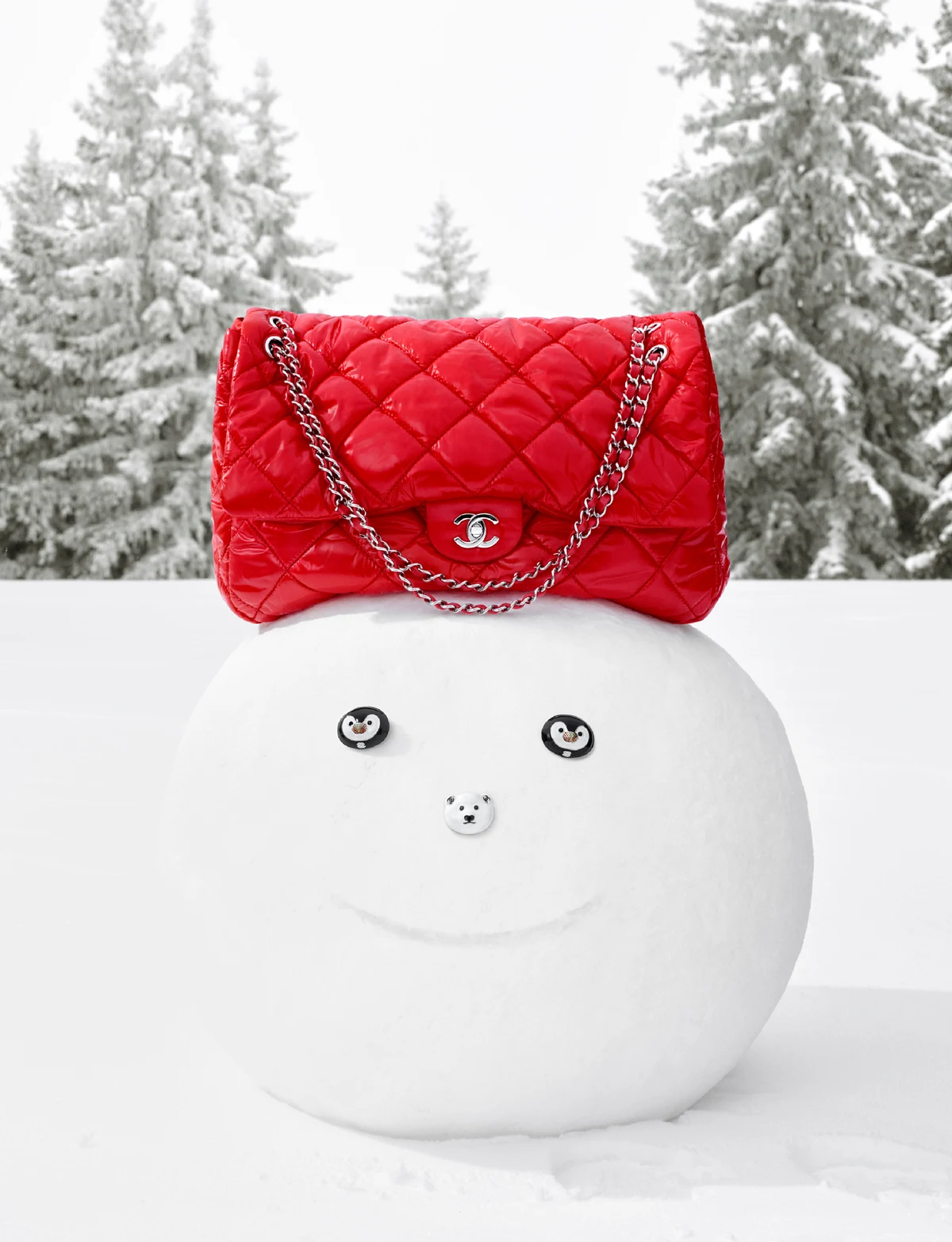 Red quilted Chanel flap bag perched on a snowman