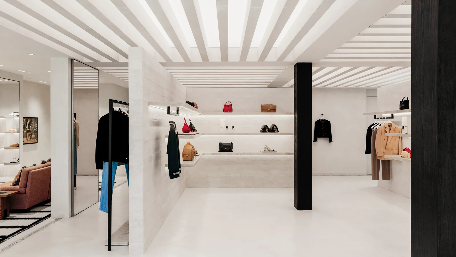The single open salon of the Chanel Los Cabos boutique, finished in travertine with ready-to-wear and bags on display