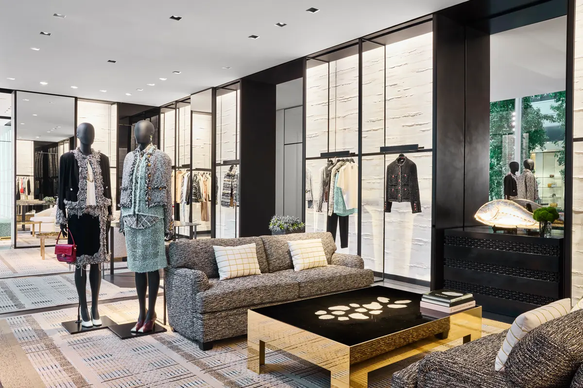 A ready-to-wear salon at the Chanel San Diego boutique with tweed looks and a gold coffee table