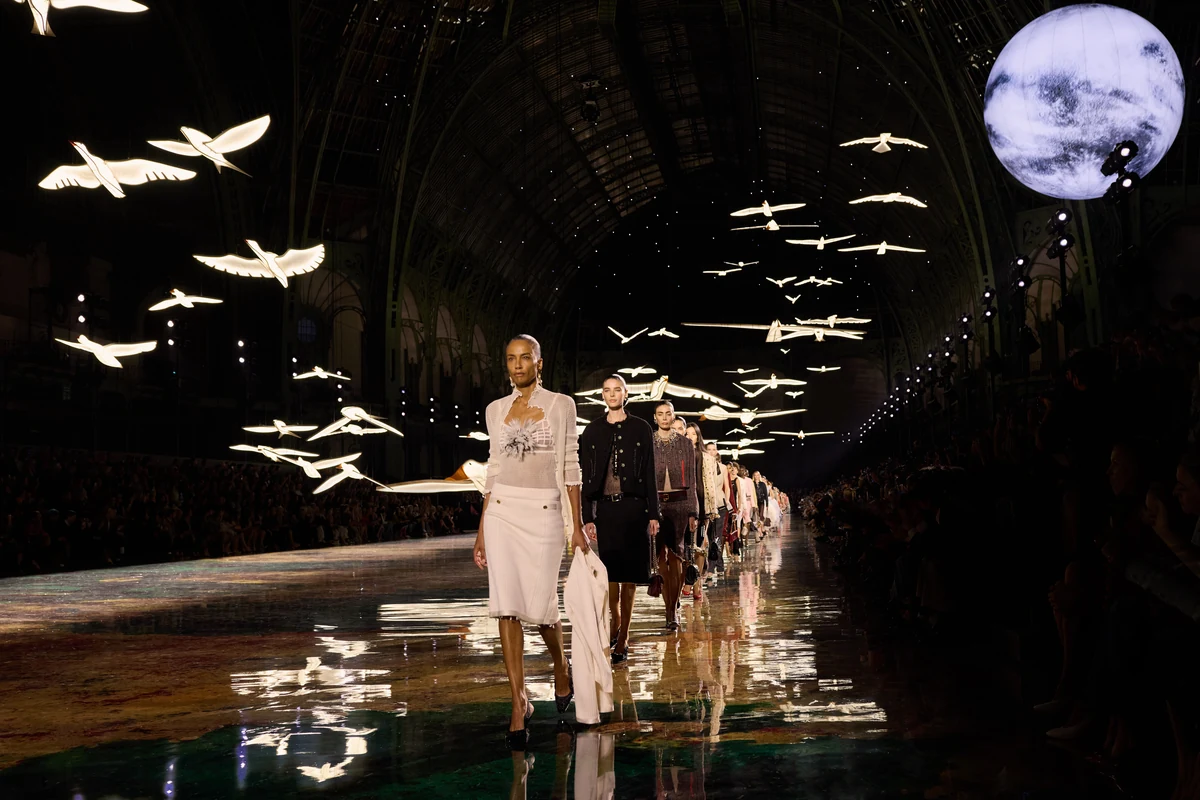Models walk the Chanel Spring Summer 2027 runway beneath illuminated birds at the Grand Palais in Paris