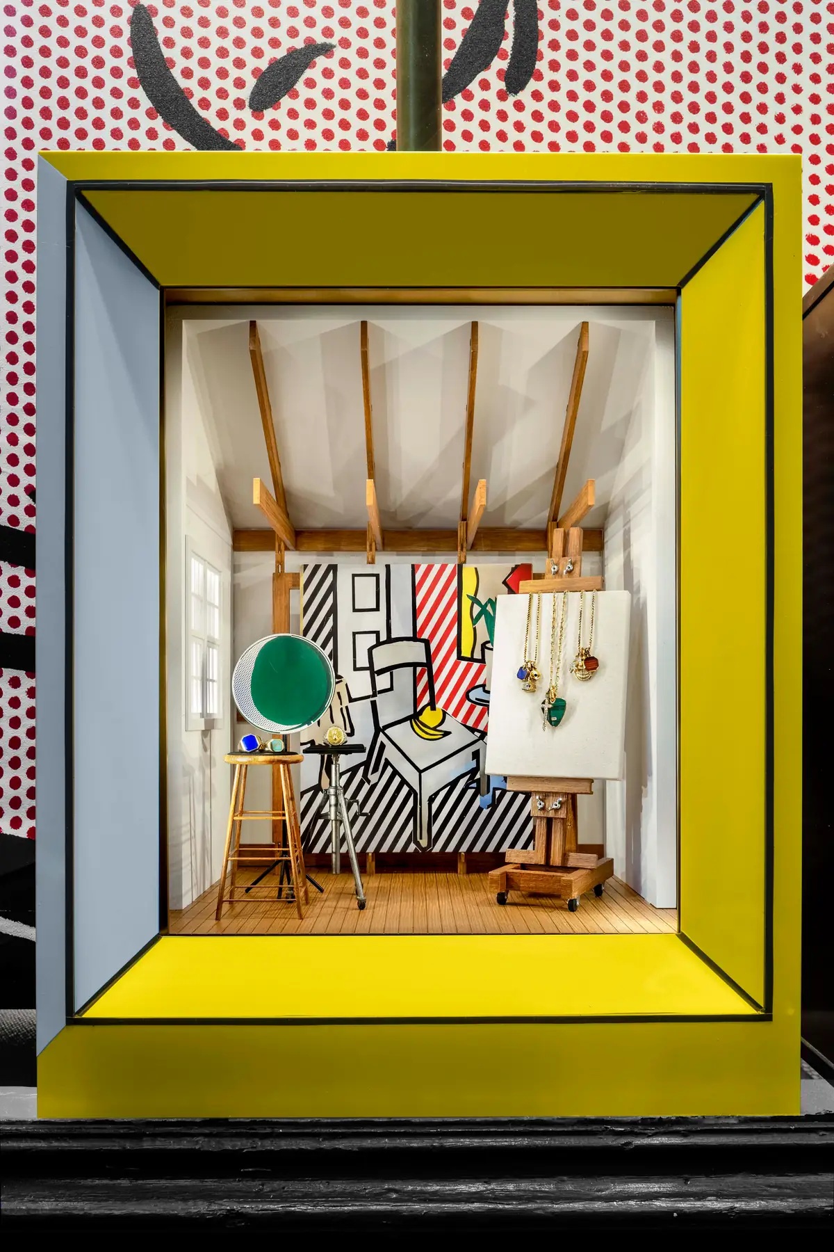 David Yurman Roy Lichtenstein Soho window vignette with pop art canvases and David Yurman jewelry displayed in a yellow-framed miniature studio