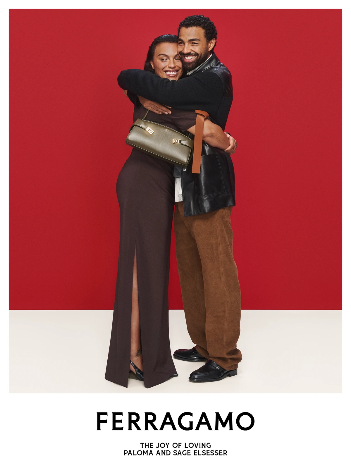 Paloma Elsesser and her brother Sage Elsesser hugging in the Ferragamo holiday campaign, she carries an olive Ferragamo bag