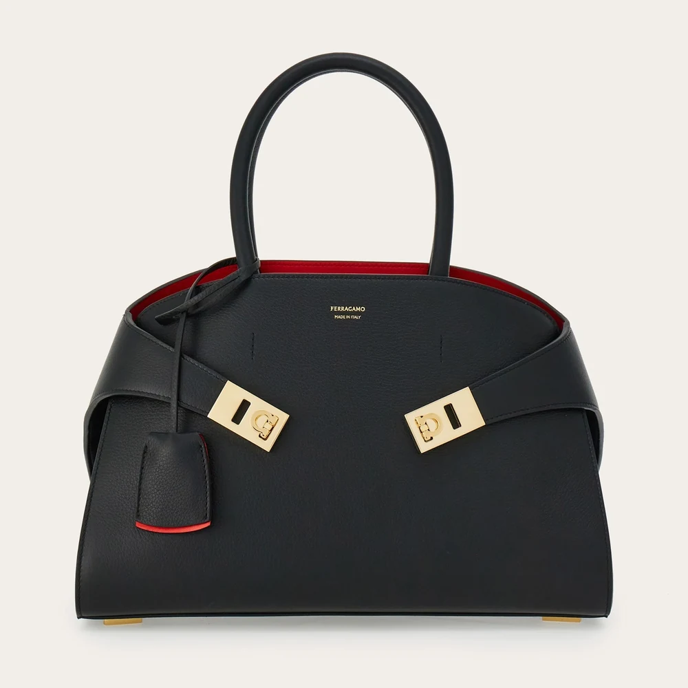 Ferragamo Hug bicolor handbag in black leather with red interior