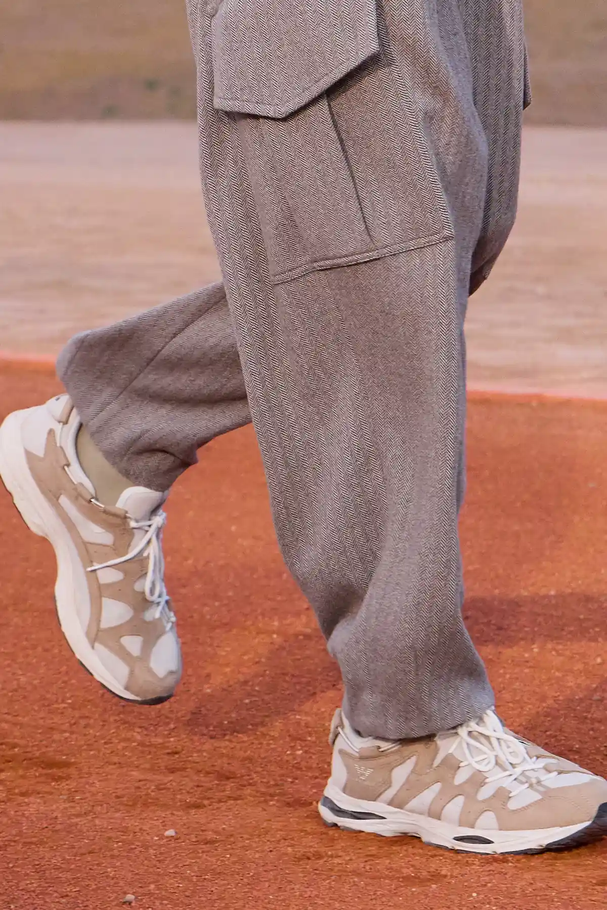 Detail of grey Giorgio Armani & Kith cargo trousers and suede sneakers on the Dreams of the Dune runway
