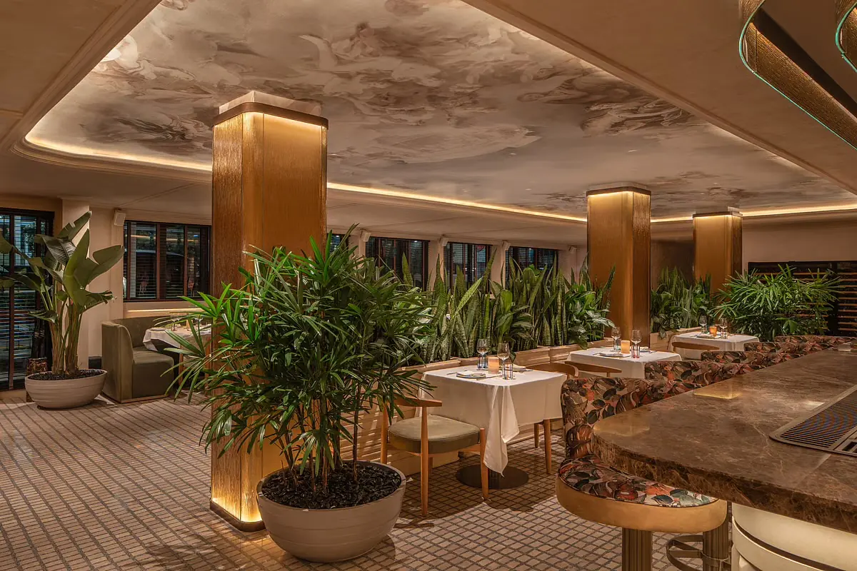 Plants and gold columns in the dining room at Harbour Club Miami Beach