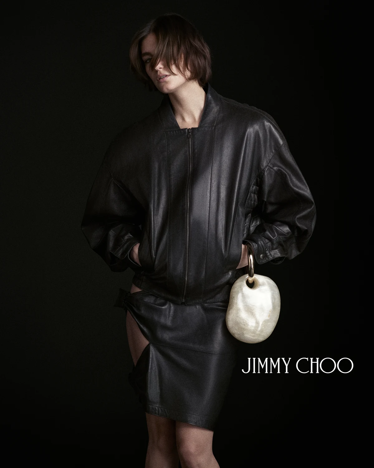 Jimmy Choo Pearls of Wisdom campaign image with the OYSTER pearl clutch and black leather look
