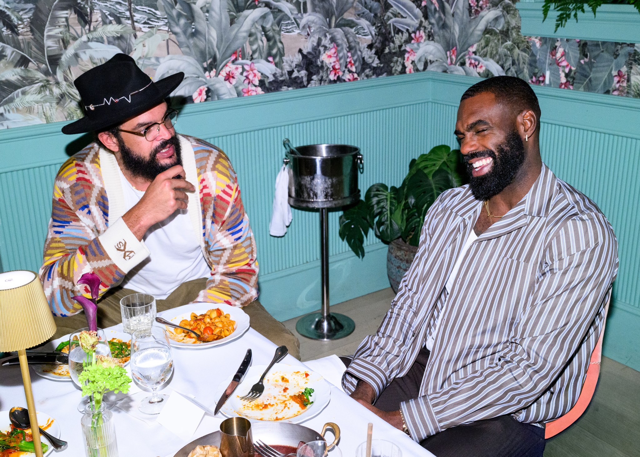 Joakim Noah and Tim Hardaway Jr. seated at the dinner table at Casadonna