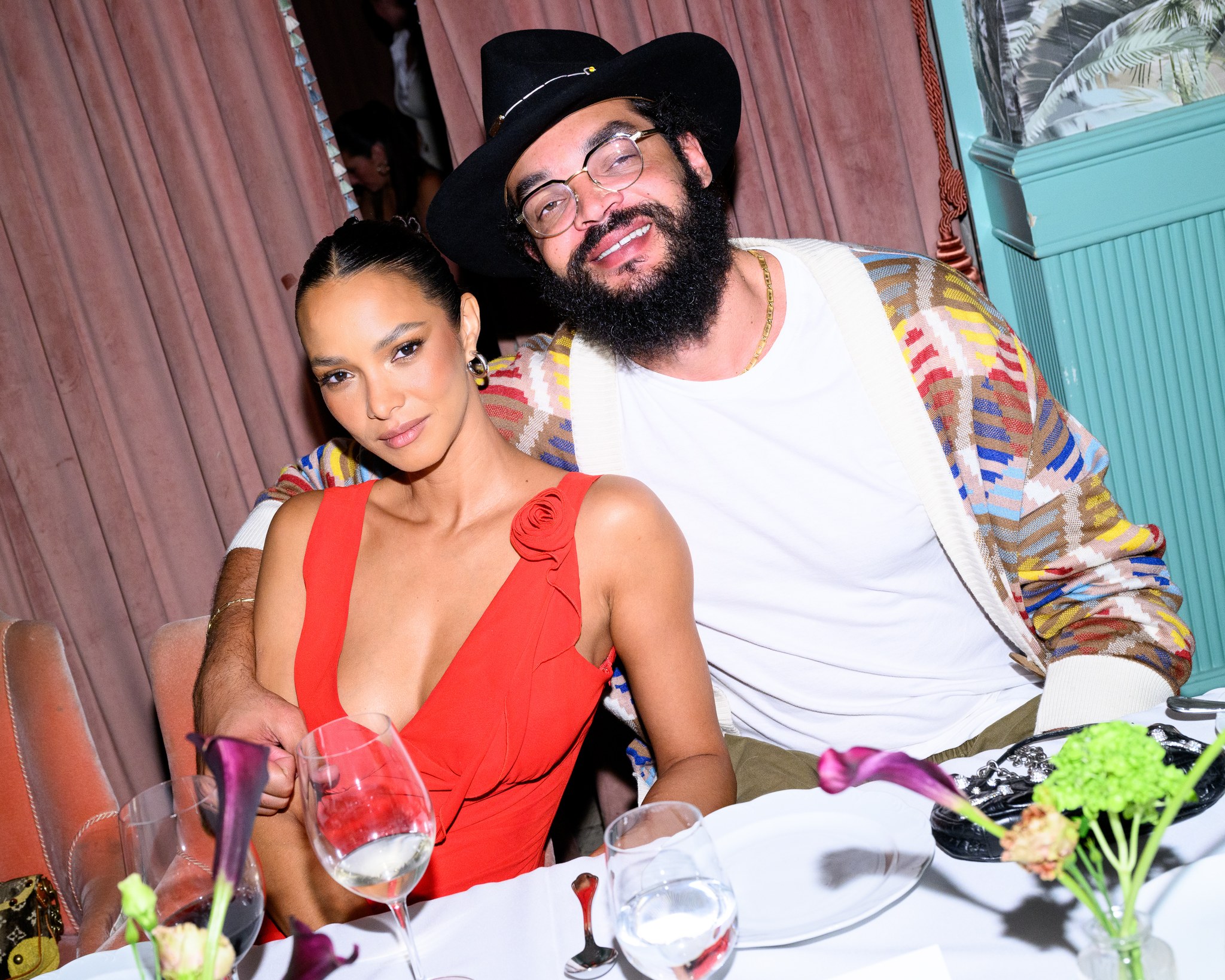 Lais Ribeiro in a red dress and Joakim Noah at the REVOLVE dinner at Casadonna in Miami