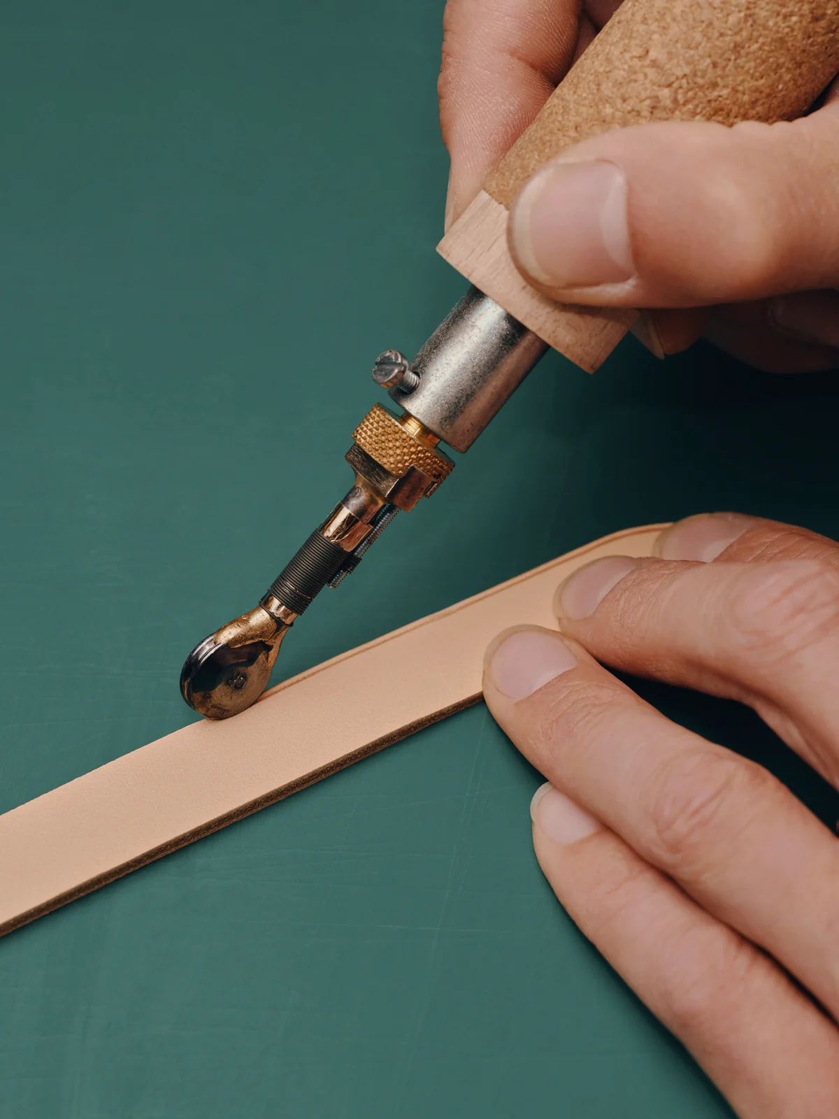 Louis Vuitton Care & Repair: artisan finishing the edge of a leather strap