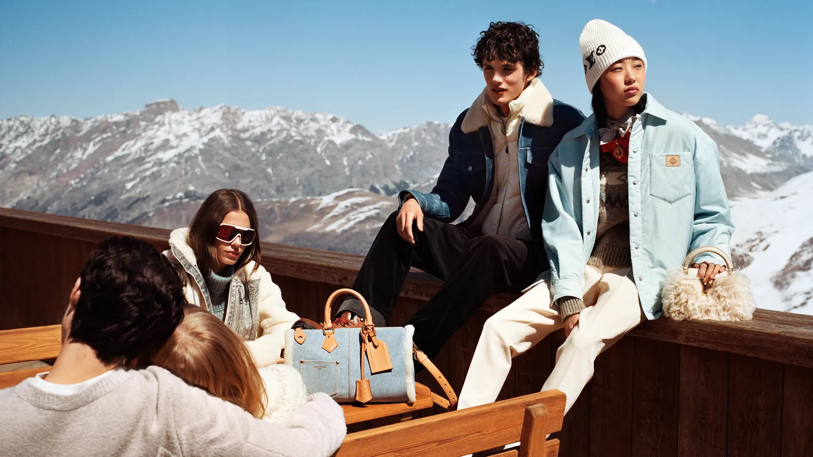 Louis Vuitton LV Ski 2026 collection après-ski looks in shearling, denim and cashmere on an alpine terrace