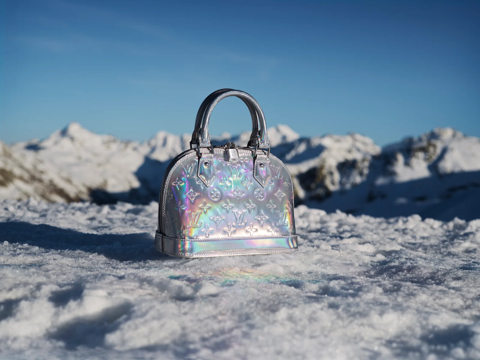 Holographic Monogram Miroir bag from the Louis Vuitton LV Ski 2026 collection in the snow