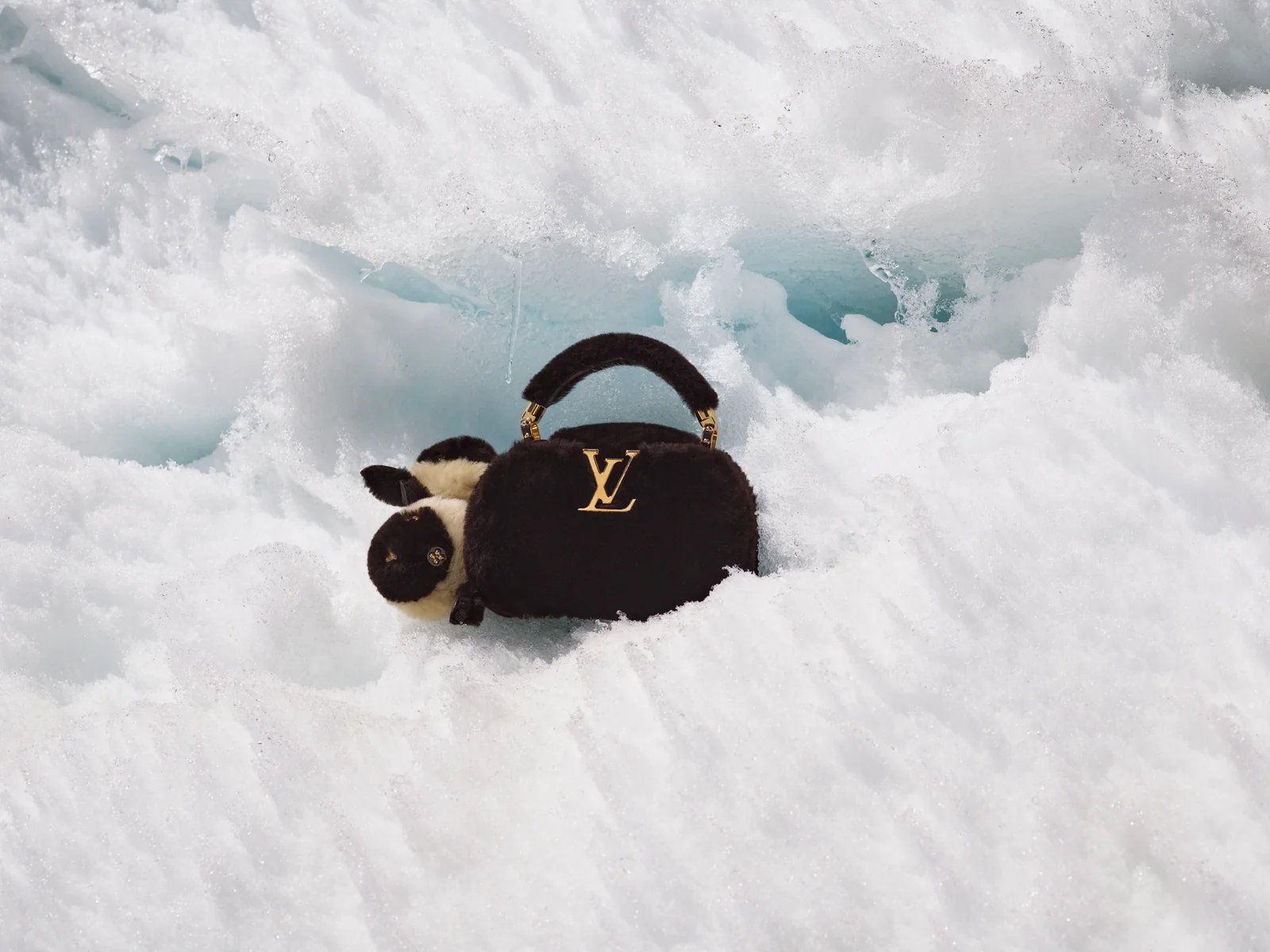 Black shearling Capucines bag from the Louis Vuitton LV Ski 2026 collection in the snow