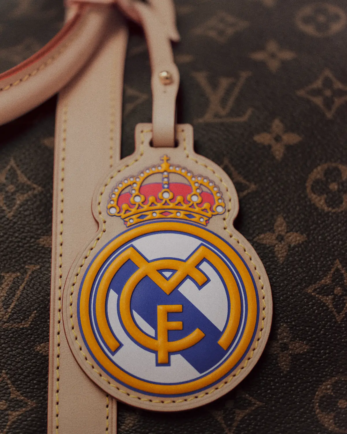 Real Madrid crest tag on Louis Vuitton Monogram canvas leathergoods from the Louis Vuitton Real Madrid collection