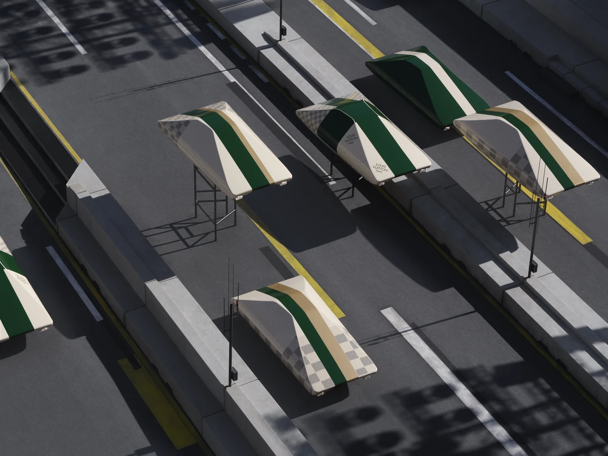 Green and cream flying cars hover on pylons above the asphalt Louis Vuitton Spring Summer 2027 runway in the Cour Carree du Louvre