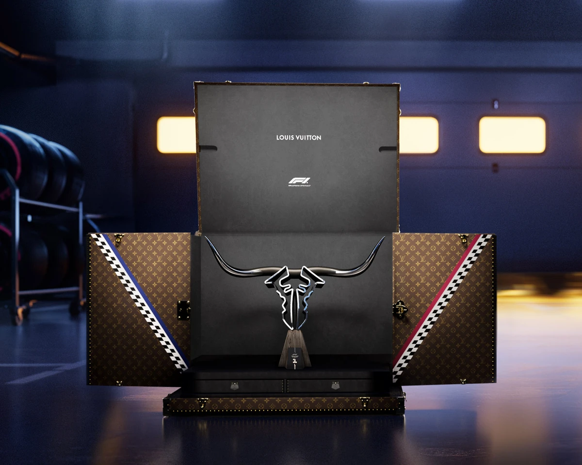 The Louis Vuitton Trophy Trunk for the Austin Grand Prix, its Monogram doors trimmed in blue, red and checkered Damier stripes around the race trophy