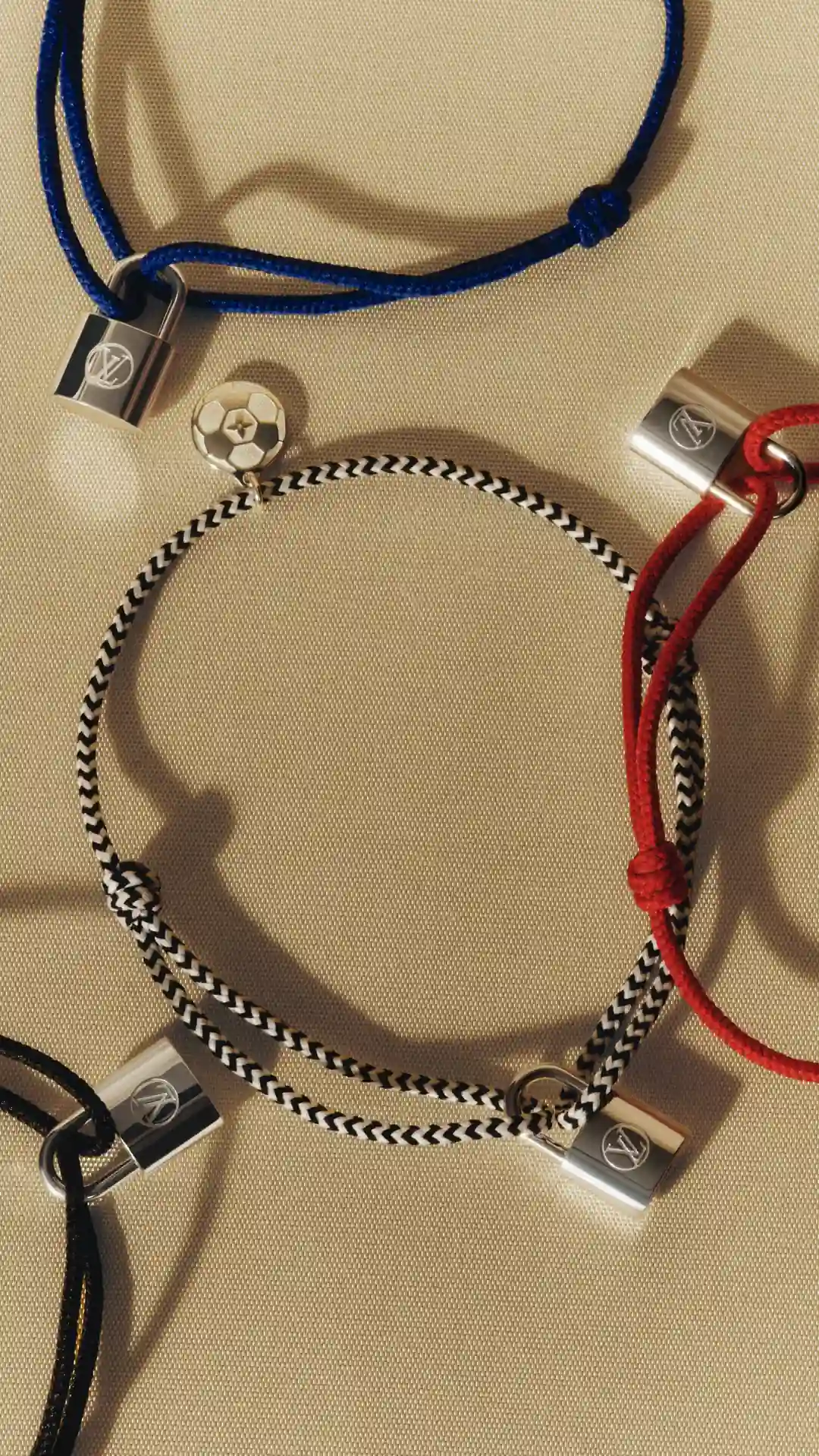 Louis Vuitton for UNICEF: Silver Lockit red and blue cord bracelets