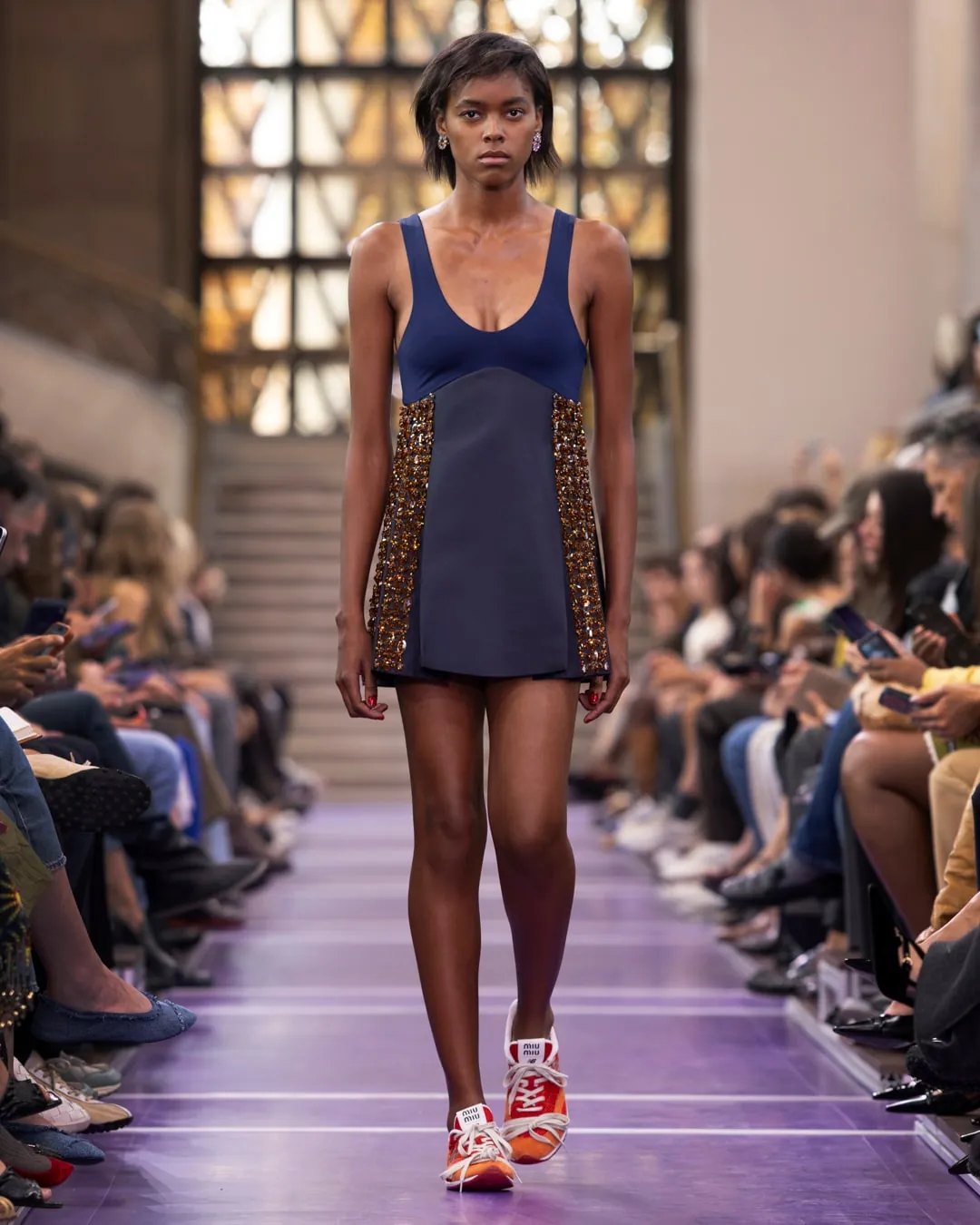 Miu Miu Spring/Summer 2027 Look 75, Gigi Hadid in a sports bra and crystal-trimmed pleated skirt, at Paris Fashion Week