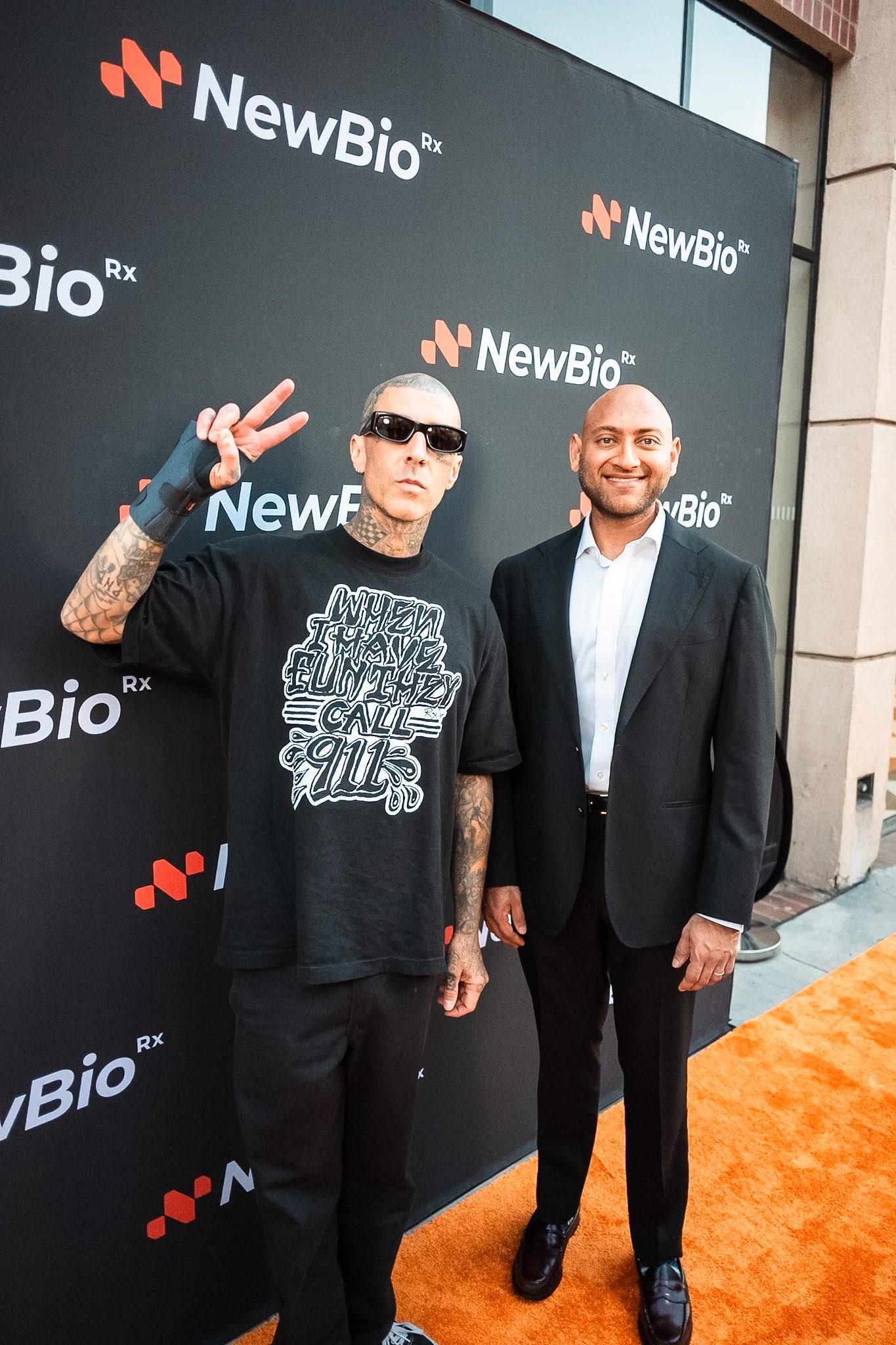 Travis Barker on the orange carpet at the NewBioRx flagship opening in Beverly Hills