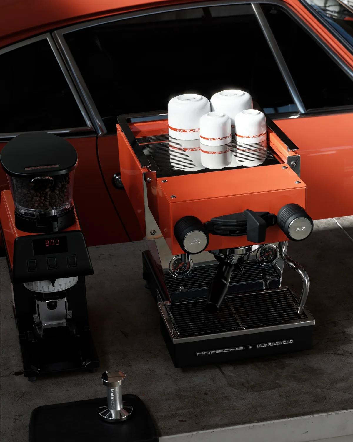 Porsche La Marzocco Linea Micra in Tangerine with Pico grinder in front of a 911 Carrera RS 2.7