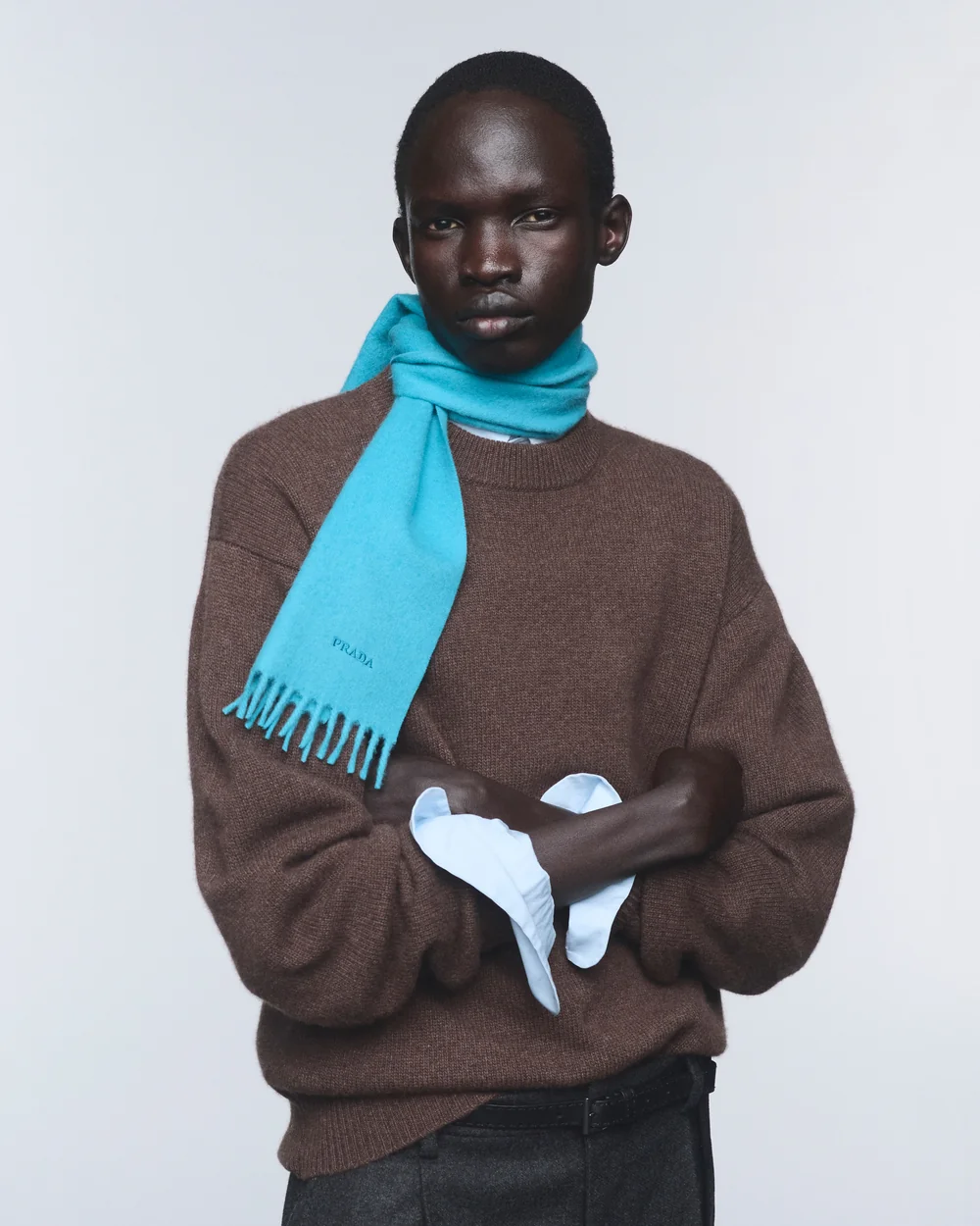 Model wearing a brown Prada Re-Cashmere sweater with a turquoise cashmere scarf