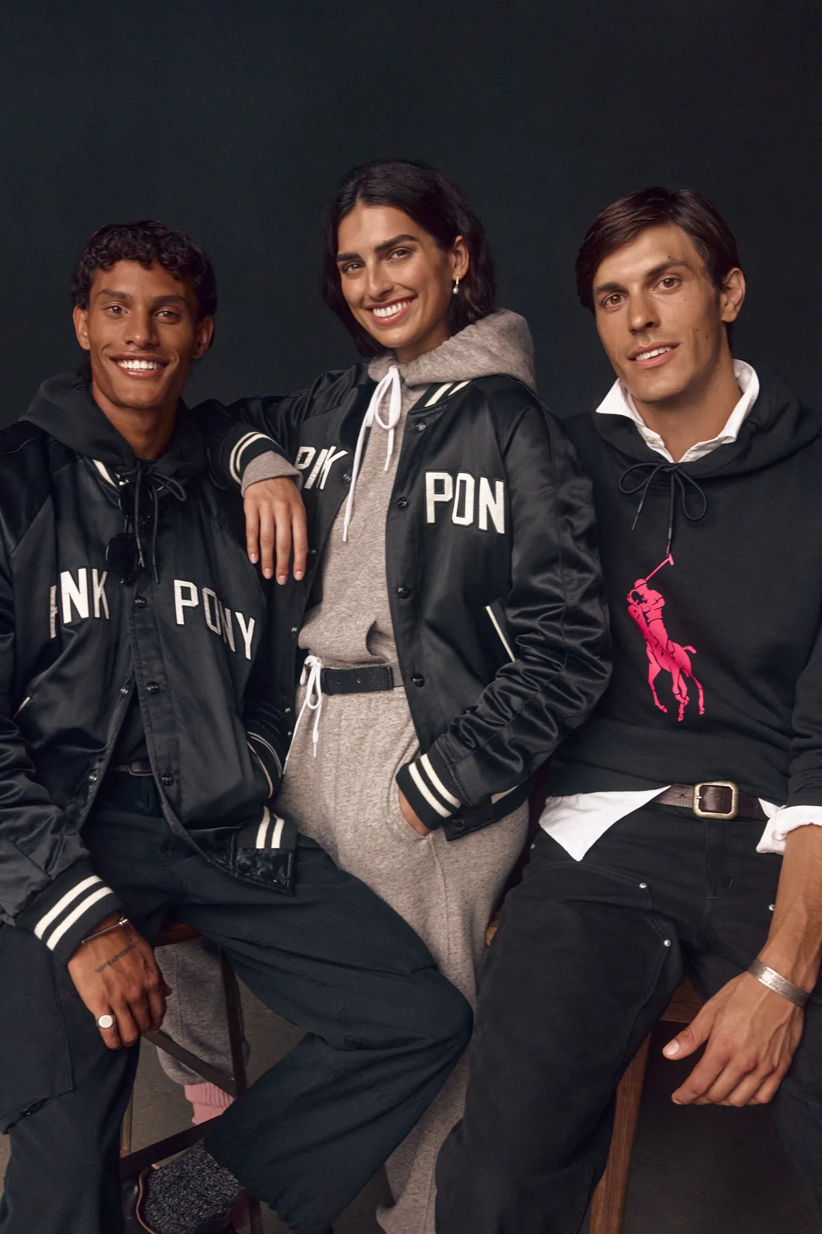 Cade Thompson, Saffron Vadher and Marko Manojlovic wearing Pink Pony satin baseball jackets and a fleece hoodie in the Ralph Lauren Pink Pony 2026 campaign