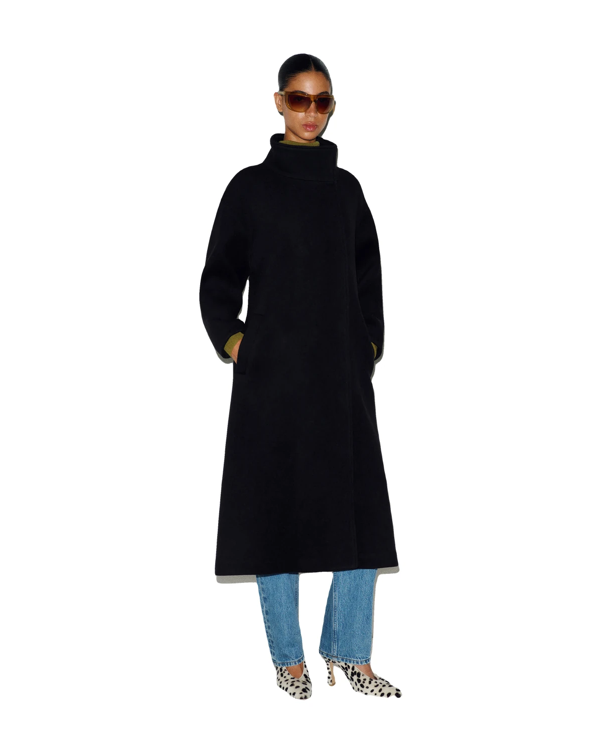 Model wearing the Reformation Addison Coat, a black full-length high-neck wool-blend coat, on a white background, one of the best luxury winter coats 2026