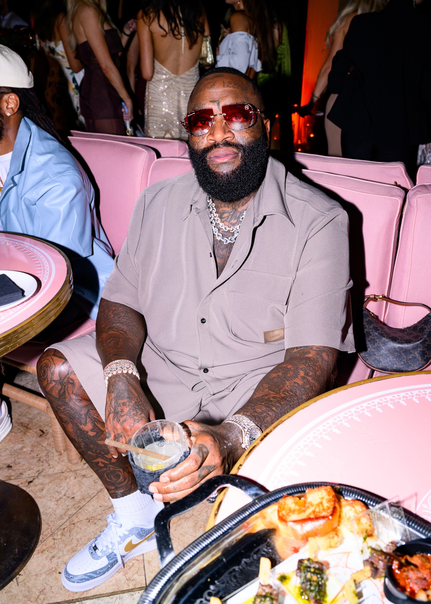 Rick Ross seated at the REVOLVE dinner for Dwyane Wade at Casadonna in Miami