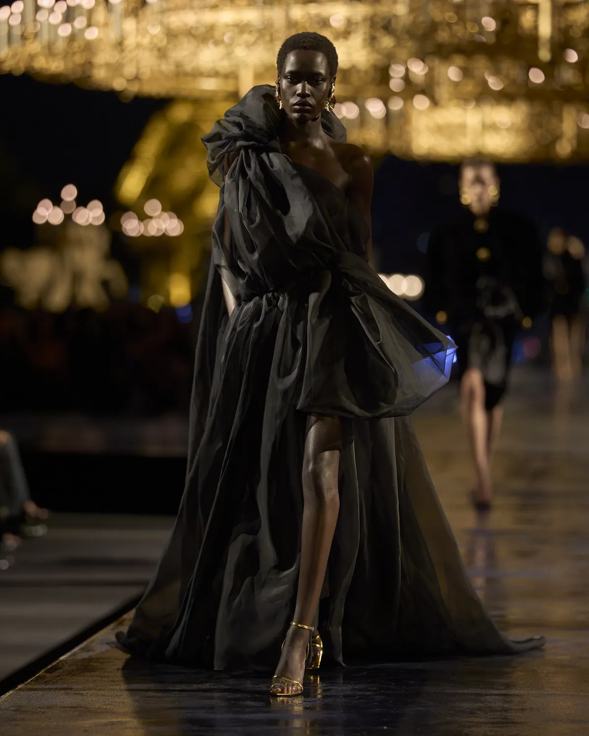 Saint Laurent Summer 2027 Look 51, a black sheer evening gown, at Paris Fashion Week