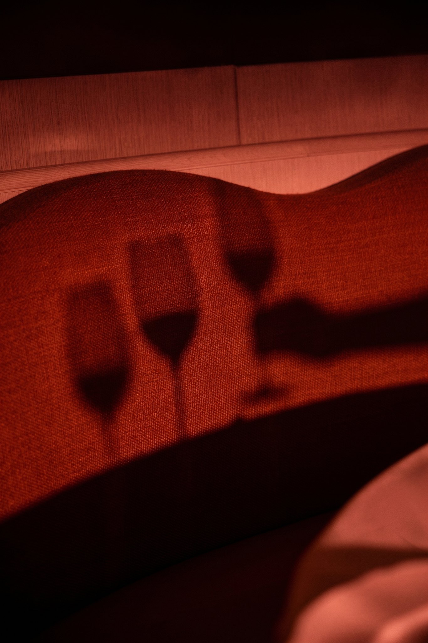 Wine glasses and shadows in low red light at Seia in Brickell