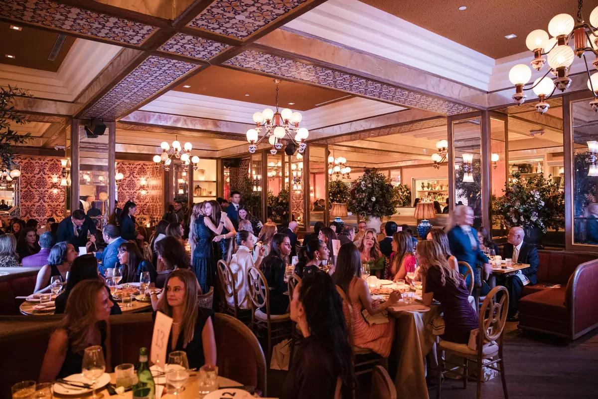 Guests at the Shoes for a Cure 2026 opening-night dinner in the dining room of Mother Wolf in the Miami Design District