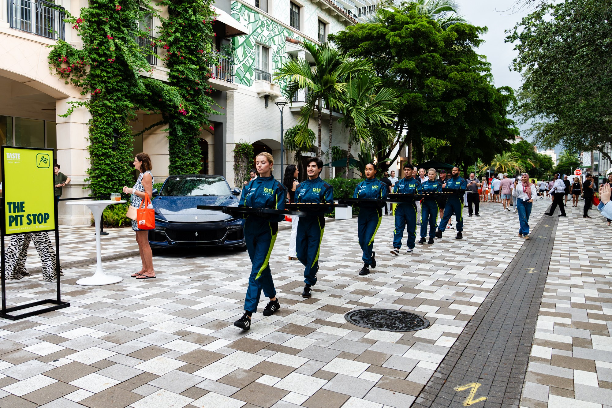 Servers in Formula 1-inspired suits during the Ferrari and Eataly pit stop at Taste of West Palm Beach