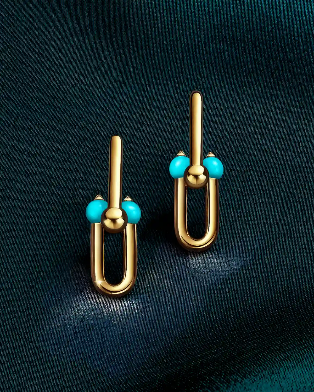Tiffany HardWear Medium Link Earrings in 18k yellow gold with turquoise beads on dark teal satin