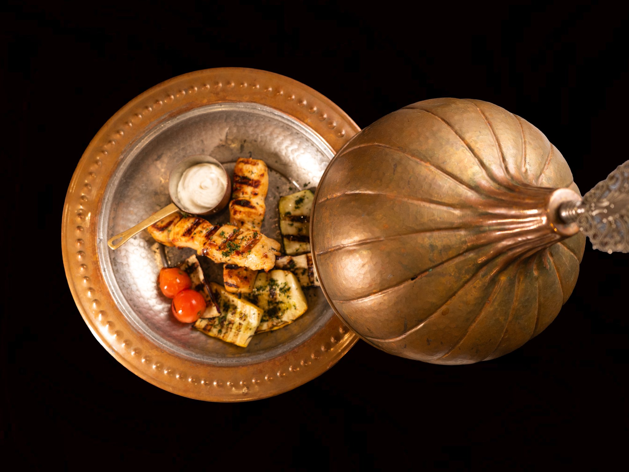 A dish served under a copper dome at Topkapi Restaurant