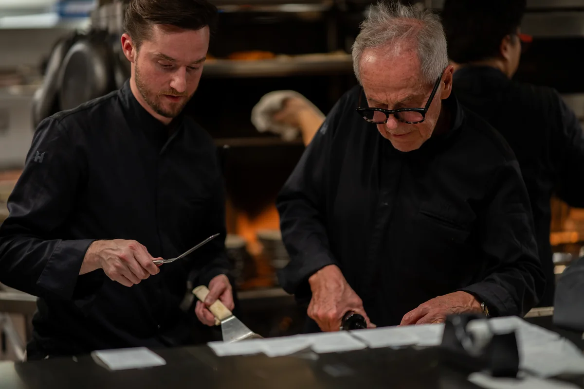 Wolfgang Puck and Byron Lazaroff-Puck plating a dish at Cut