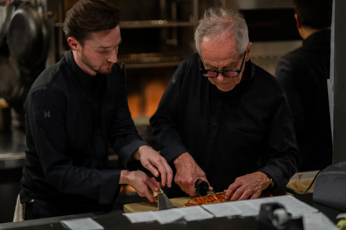 Wolfgang Puck and Byron Lazaroff-Puck slice a tart together
